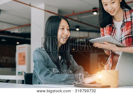 Young Studebt Sitting In Library College Studying And Sharing Knowledge With Laptop Together, Educat