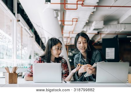 Young Studebt Sitting In Library College Studying And Sharing Knowledge With Laptop Together, Educat