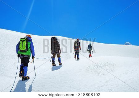 Hikers With Backpacks Reaches The Summit Of Mountain Peak, Nepal