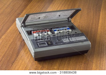 Old Vintage Answering Machine With Two Small Tape Cassettes On A Wooden Table Surface