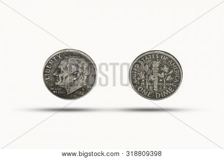 Closeup Of One Dime Coin With Shadow On White Background. Us Dollar Is Worldwide Currency And Popula