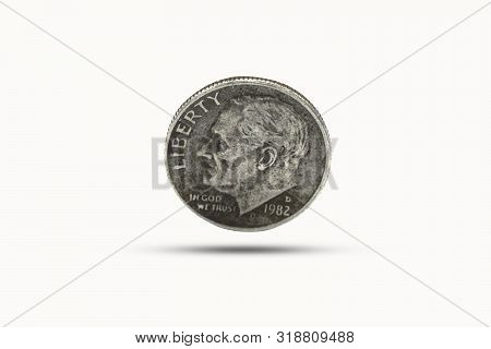 Closeup Of One Dime Coin With Shadow On White Background. Us Dollar Is Worldwide Currency And Popula