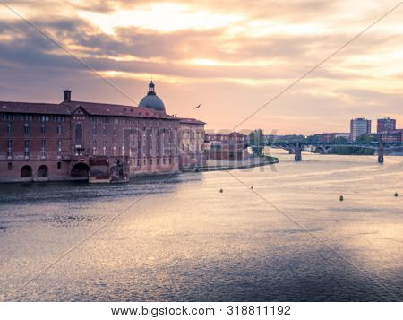 sunset on a bridge of Toulouse over the Garonne river, France
