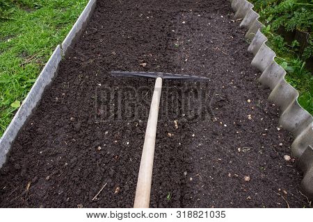 Loosening The Excavated Ground With A Rake Close-up