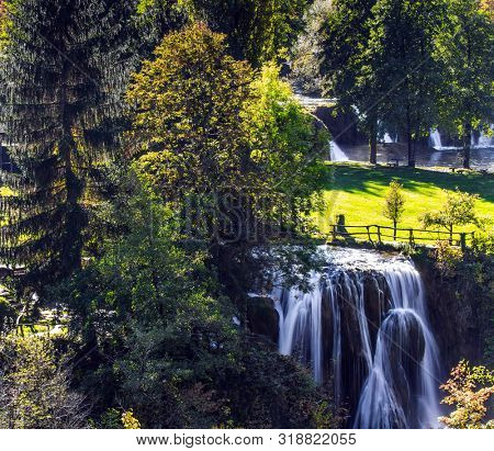 Travel to Croatia. Sunny lawn at the waterfall. The Croatian town of Slunj. Cascade of waterfalls on the Sluncica River. The concept of ecological, active and photo tourism