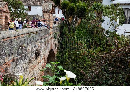 Mongui, Colombia - August, 2019: Tourists Visiting The Royal Bridge Of Calicanto At The Beautiful Sm