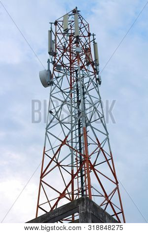Cell Radio Phone Tower Standing Under The Nice Sky.