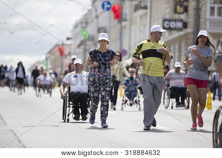 Belarus, The City Of Gimel, July 03, 2019. Youth Festival.a Man In A Wheelchair And Healthy People C