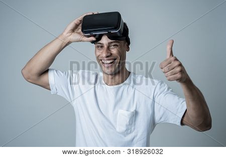 Portrait Of Cheerful Young Man Wearing Virtual Reality Goggles For First Time Smiling At Camera