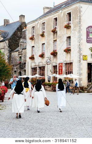 Rochefort-en-terre , France - July 26, 2018: Nuns Walking By The Picturesque Medieval Village, One O