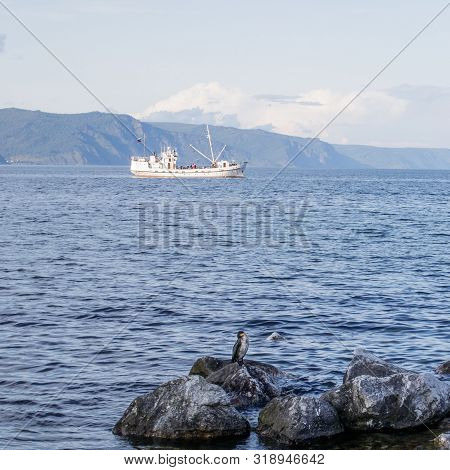 View Of Lake Baikal Near City Of Slyudyanka, Irkutsk Region, Russia. In Foreground Is Cormorant On D