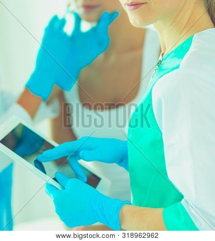 Portrait of female standing near open fridge full of healthy food, vegetables and fruits. Portrait of female