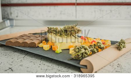Preparing To Cooking Cake With Cannabis Butter. Concept Of Using Marijuana In Food Industry.