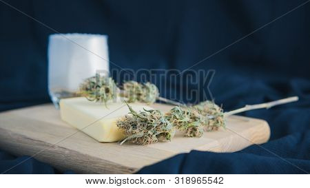 Preparing To Cooking Cake With Cannabis Butter. Concept Of Using Marijuana In Food Industry.