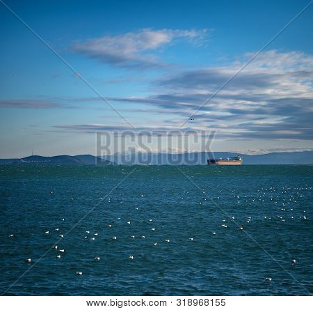 A Lonely Tanker In The Roadstead In Front Of The Entrance To The Bosphorus Strait, Against The Backd