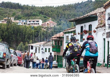 Mongui, Colombia - August, 2019: Tourists And Locals At The Beautiful Streets Of The Small Town Of M