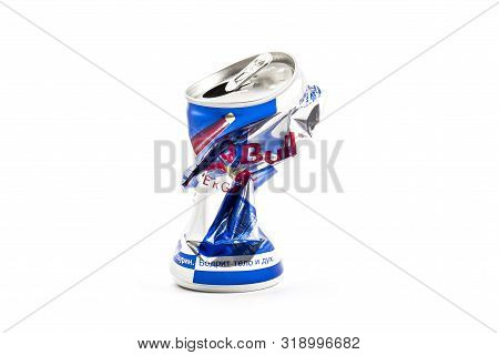 Sankt-petersburg, Russia - August 08, 2019:  Crumpled Aluminum Can Of Redbull Drink Over White Backg