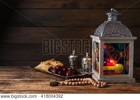 Arabic Lantern And Misbaha On Wooden Table. Space For Text
