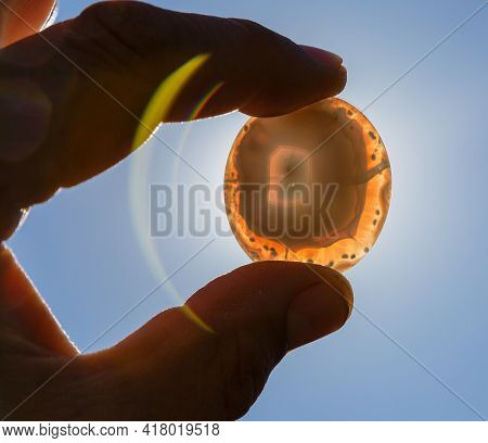 Semi-precious Stone Agate In Hands In Backlight