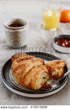 Breakfast With Croissant, Jam And Hot Chocolate, Juice And Tangerine On Greige Linen Tablecloth. Sel
