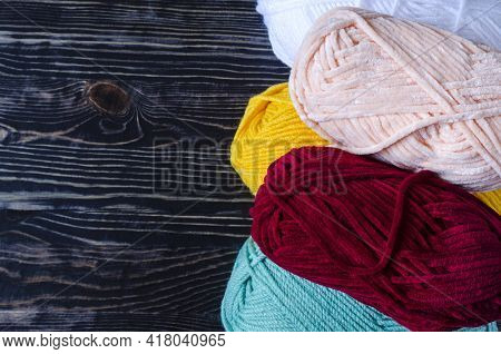 Skeins Of Colored Yarn On A Dark Wooden Background Needlework On A Background Of Self-isolation Knit
