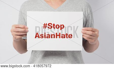 Stop Asian Hate In Red Color Write In White Board Paper.asian Man Holding Paper On White Background.