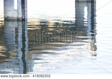 Steel Supports Under A Boardwalk Coming Up Out Of The Water