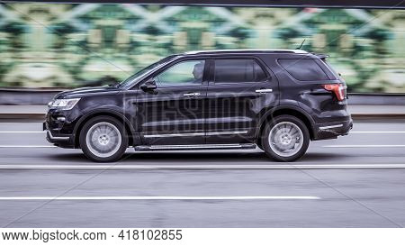 Moscow, Russia - April 2021: Fast Moving Suv Rides On City Road. Black Car Ford Explorer U502 Faceli
