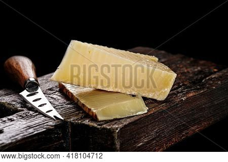 Close-up Of Cheddar Cheese. Semi-soft Aged Cow's Milk Cheese According To An Old English Recipe. Pie