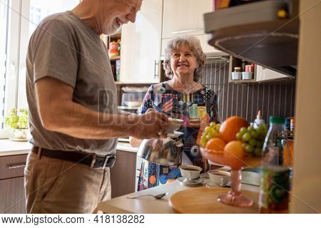 Senior couple together in their kitchen at home
