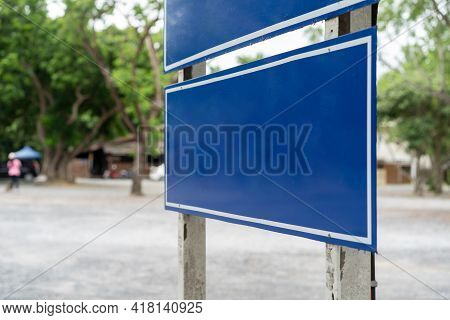 Blue Traffic Sign In Paking Lots With Tree Around. Clipping Paths
