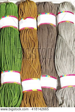 Rolls Of Polyester Cord In Various Vibrant Colors Of Green, Brown And Gray, Rolled. Vertical Image, 