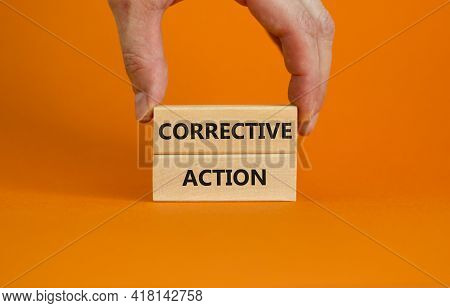 Corrective Action Symbol. Wooden Blocks With Words 'corrective Action' On Beautiful Orange Backgroun