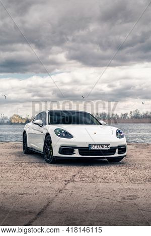 Kherson, Ukraine - March 2021. Hybrid Porsche Panamera 4 In A White Color On The Background Of The R