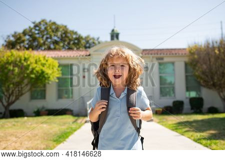 Funny School Boy Face. Child Pupul With Rucksacks In The Park Near School. Schoolboy With Backpacks 