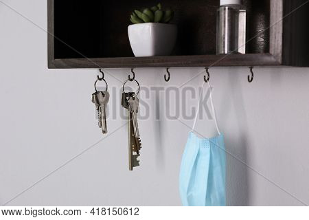 Wooden Hanger For Keys With Different Stuff On Light Grey Wall