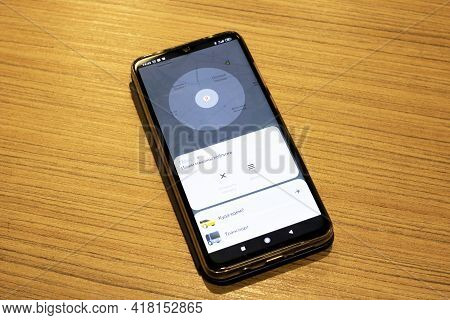 Belars, Nvopolotsk - April 20, 2021: Yandex Taxi On The Phone Display On Wooden Table