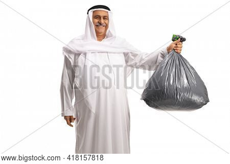Mature arab man holding a plastic waste bag and smiling isolated on white background