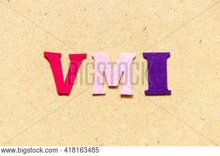 Color Cloth Alphabet Letter In Word Vmi (abbreviation Of Vendor Managed Inventory) On Wood Backgroun