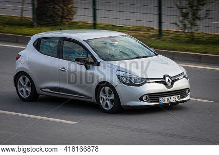 Alanya, Turkey  - April 13  2021:  Silver Renault Clio   Is Driving Fast On The Street On A Warm Sum