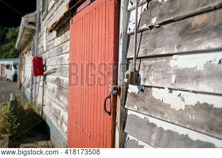 Delapidated Building With Red Door Needs Some Repair