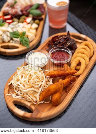 Assorted Beer Snacks, Fast Food. Bbq Wings, Onion Rings, Cheese, Meats With Cold Summer Coctail