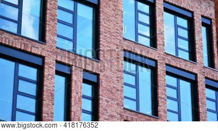 Modern Brick And Glass Facade Of The Office Building.  A Contrasting Combination Of Sky And Brick Te