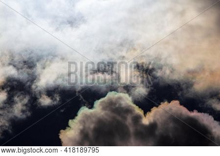 White Clouds With Iridescence Against The Blue Sky