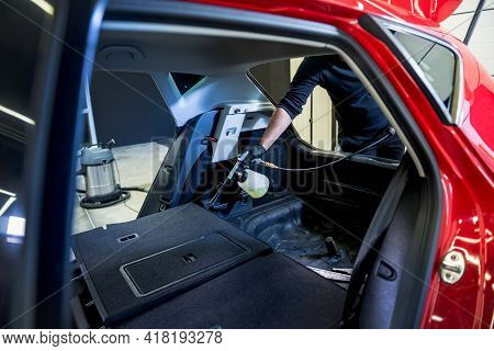 A Car Service Worker Cleans Interiror With A Special Foam Generator