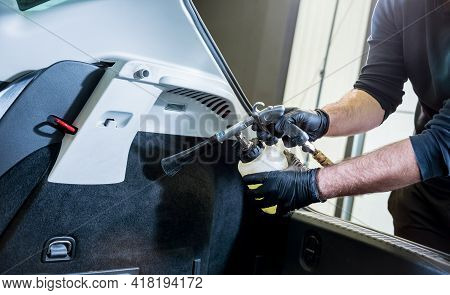 A Car Service Worker Cleans Interiror With A Special Foam Generator