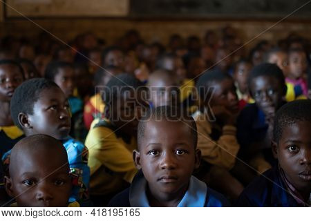 Mzuzu, Malawi. 30-05-2018. Portrait Of A Black Child Looking At The Camera While Attending School Wh