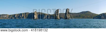 Exit On A Yacht To The Avacha Bay Of The Pacific Ocean. Panorama View Of The Rocks Three Brothers Ar