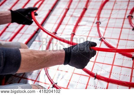 Pipefitter Install System Of Underfloor Heating System At Home