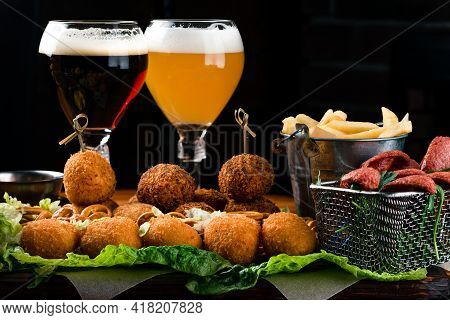 Brazilian Appetizer Deep Fried Cheese Croquette With Two Glasses Of Beer
